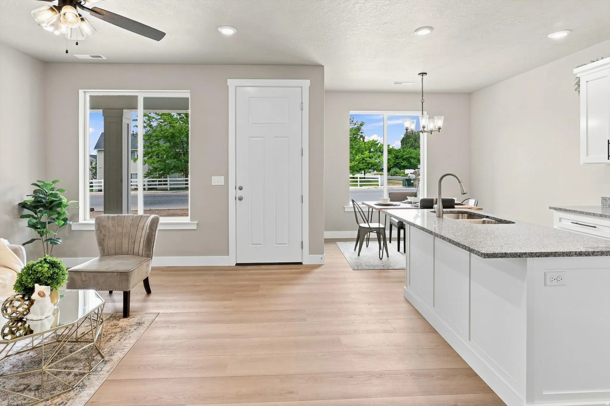 Wood-finish flooring throughout, bright white trim, recessed lighting, and a modern ceiling fan