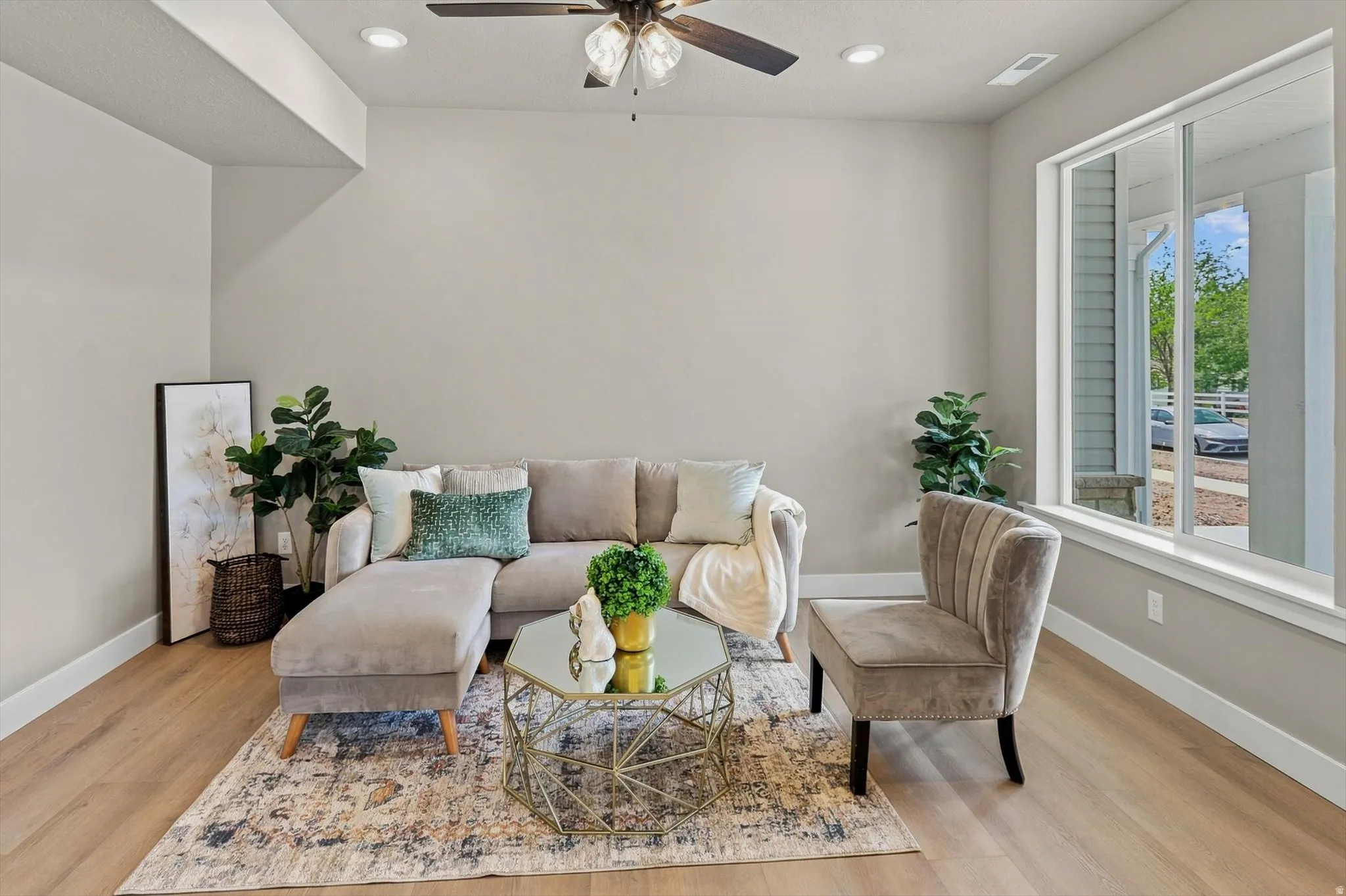 Recessed lighting, ceiling fan, wood-finish flooring, and large window