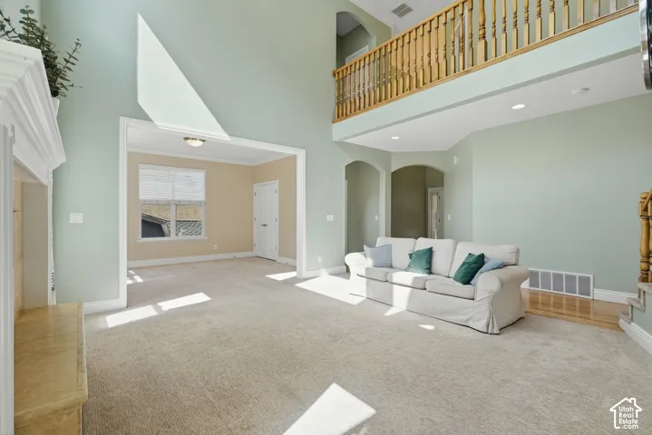 Vaulted ceilings, a second-story open railing, a built-in fireplace, and arched doorways define this living space