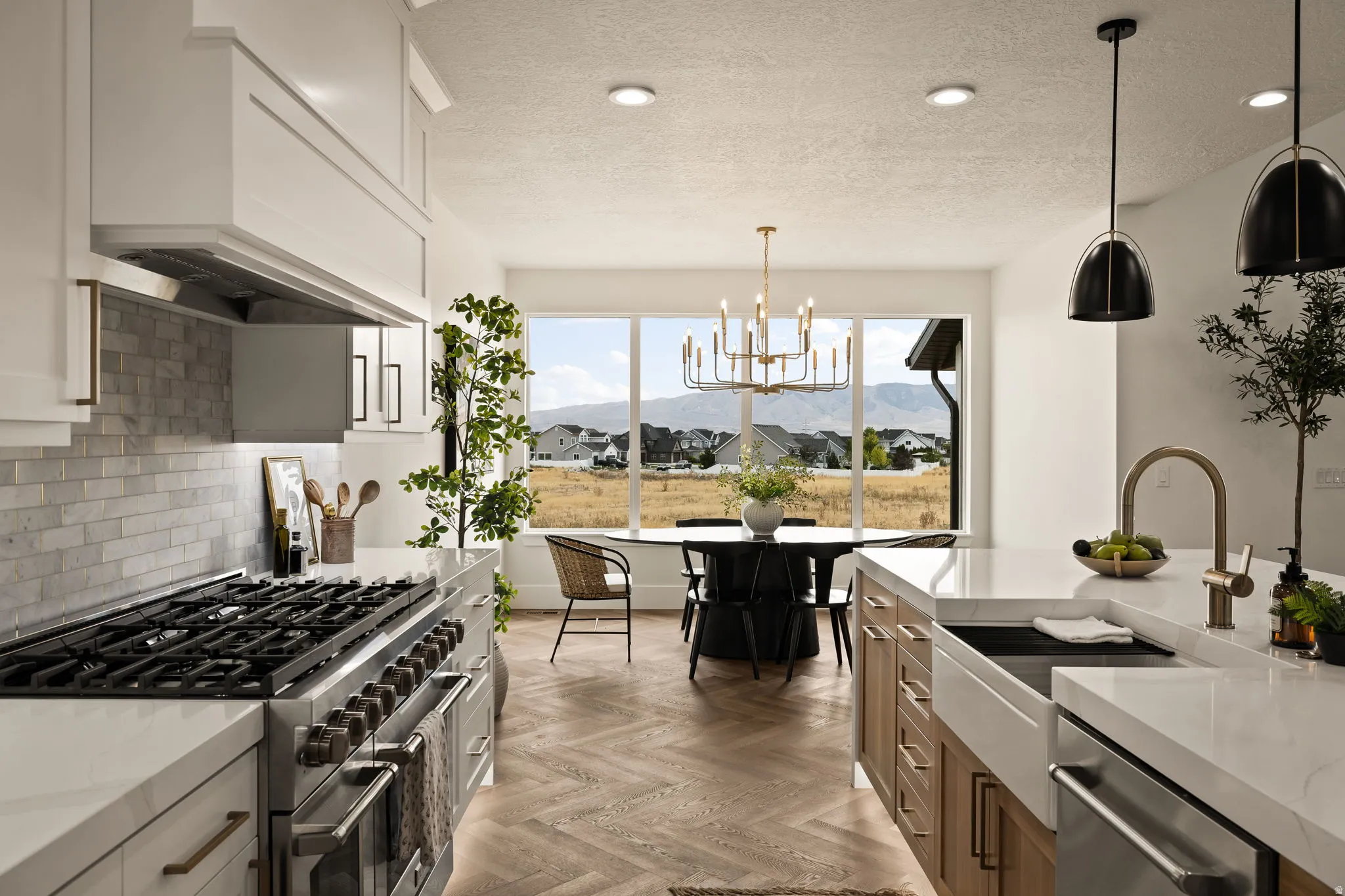 Gourmet kitchen featuring a large range with a custom hood, white cabinetry, a subway tile backsplash, and a large island with a farmhouse sink