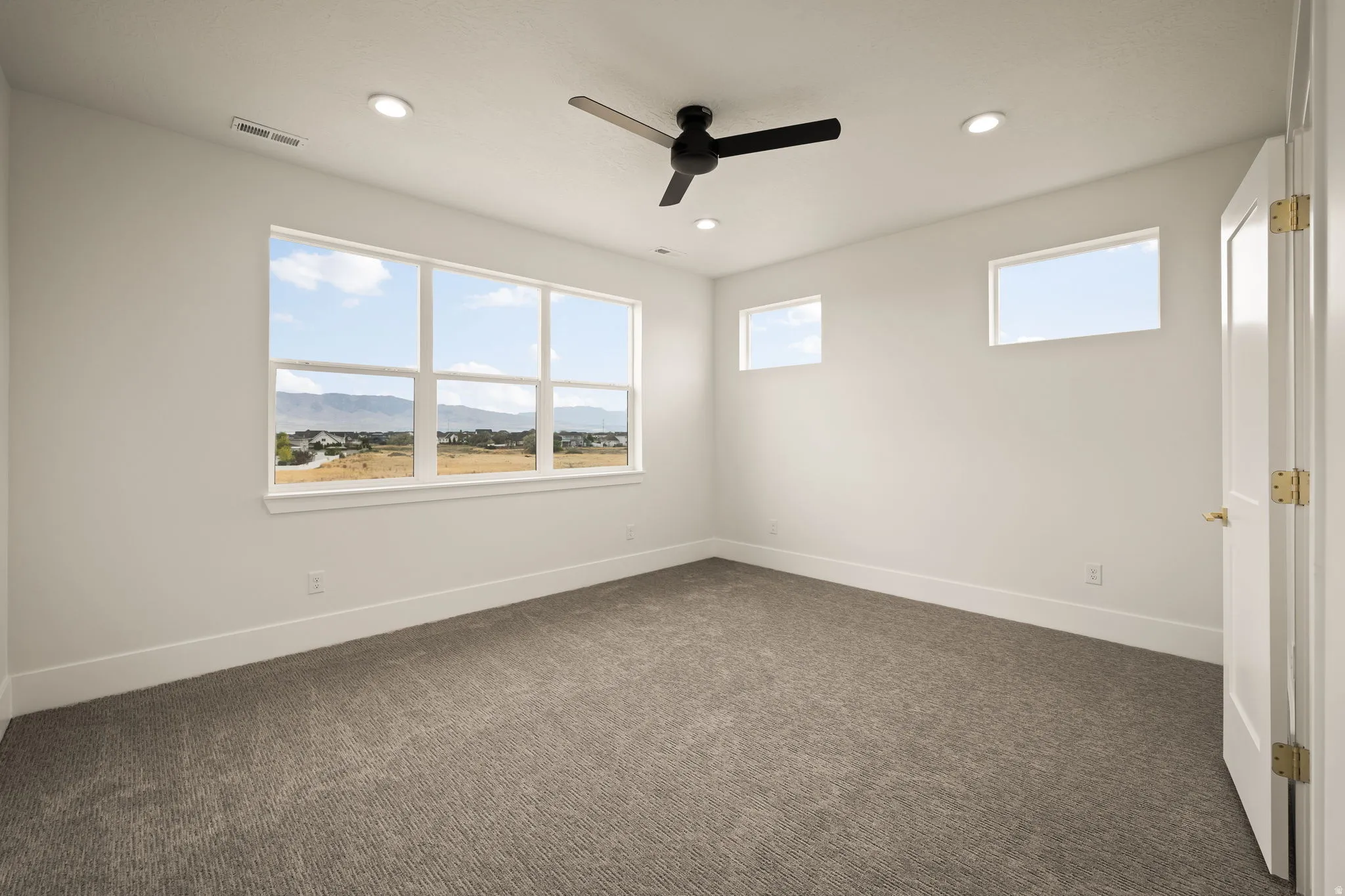 Room featuring a large picture window and two transom windows