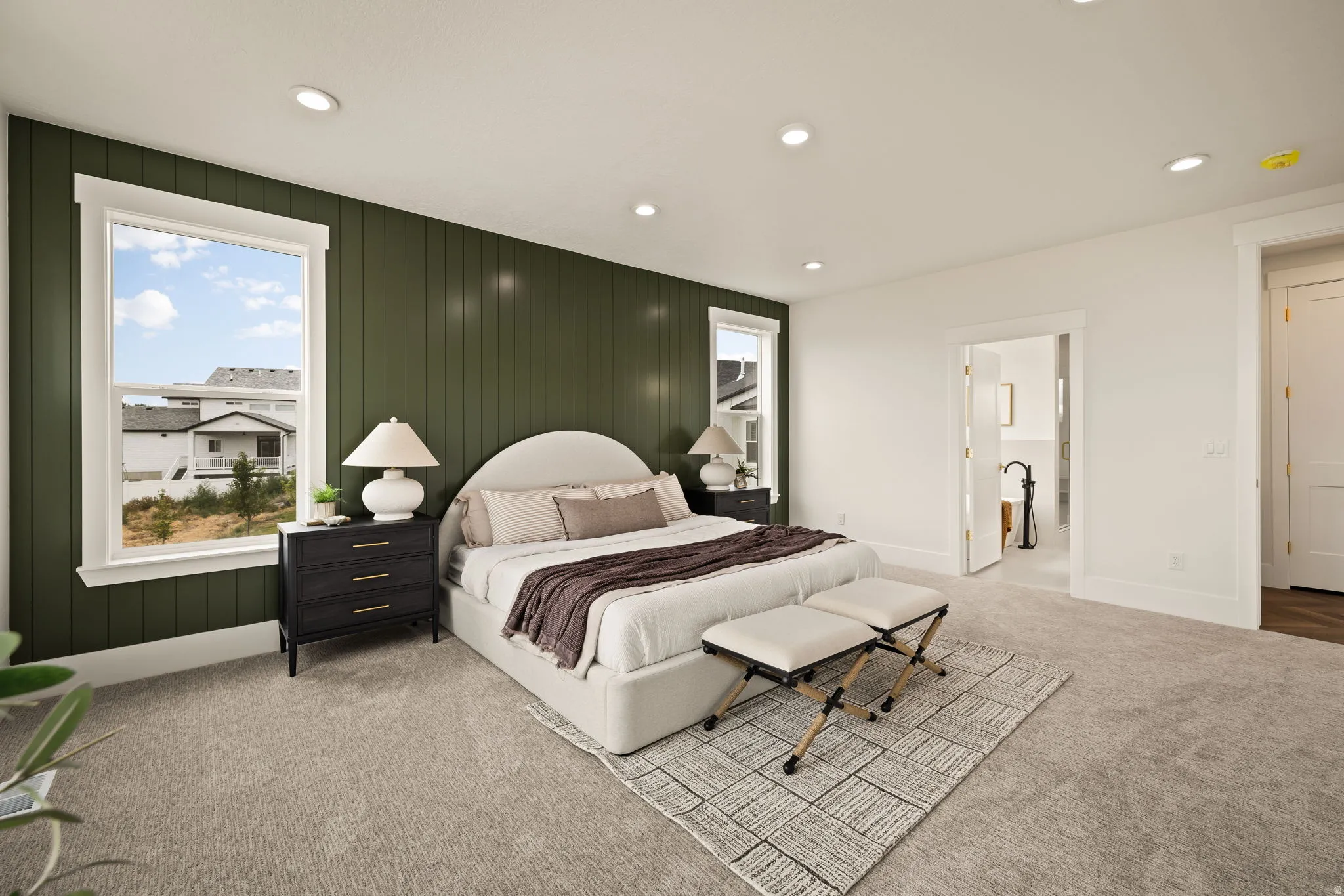 Accent wall featuring vertical paneling and two windows with white trim