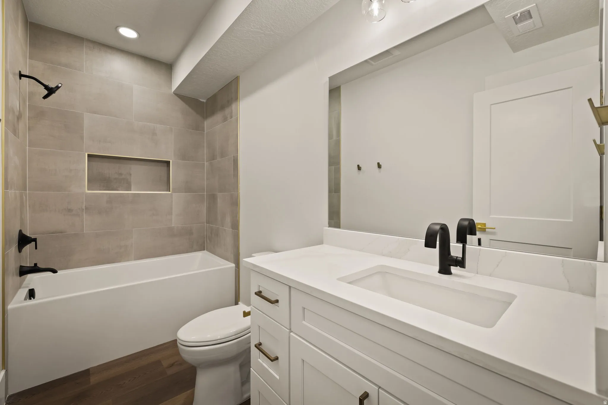 Modern bathroom featuring a white vanity with an integrated rectangular sink, a white countertop, and matte black fixtures