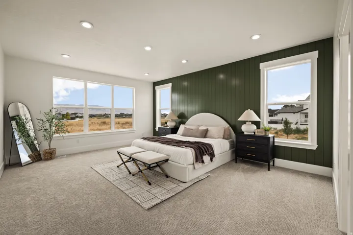 Spacious bedroom with a shiplap accent wall, multiple windows, plush carpet flooring, and recessed lighting