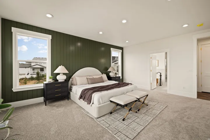 Accent wall featuring vertical paneling and two windows with white trim