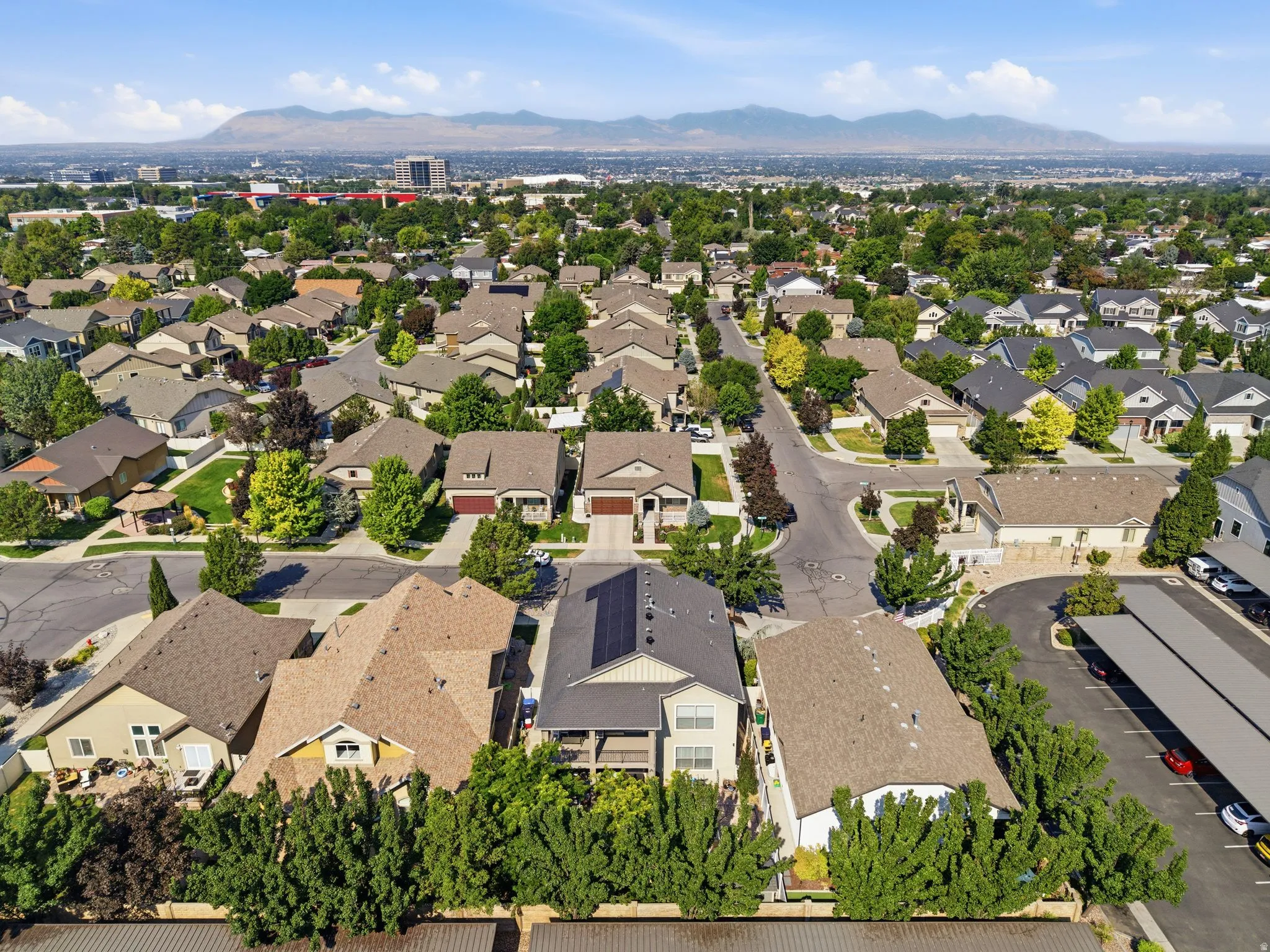 Aerial perspective of a developed residential area with numerous single-family homes and mature trees