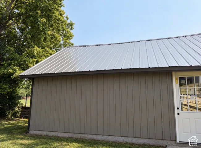 Metal roof over board and batten siding