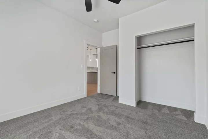 Bedroom featuring neutral gray carpeting and white walls