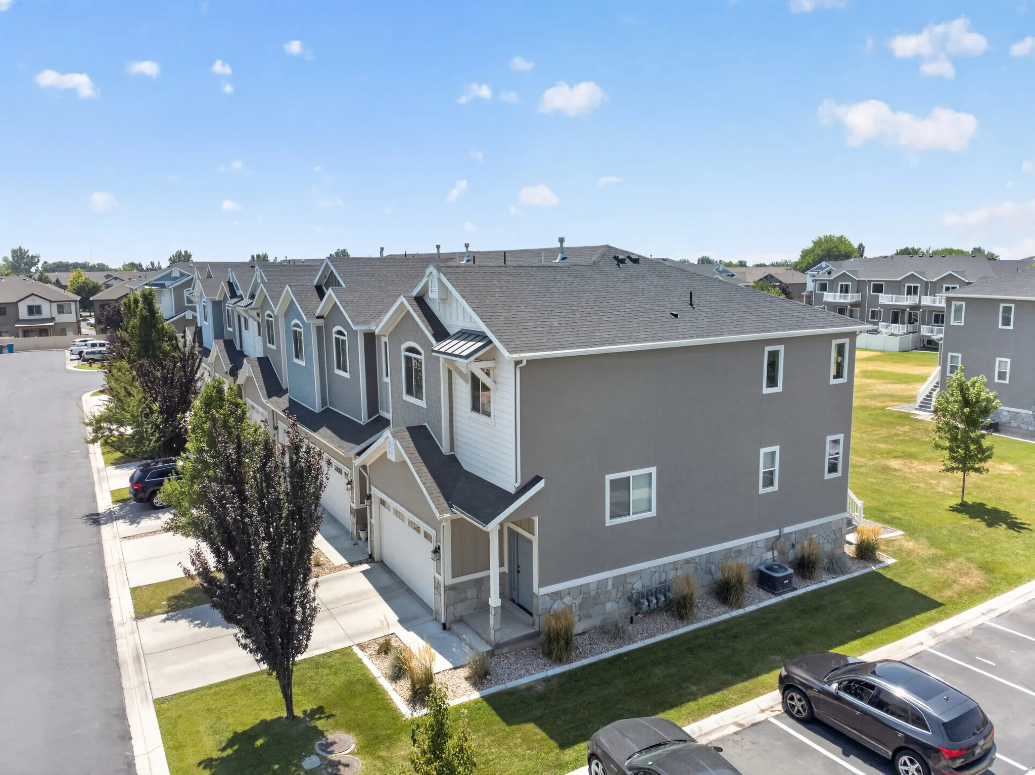 Townhome row with multi-toned siding and stone accents