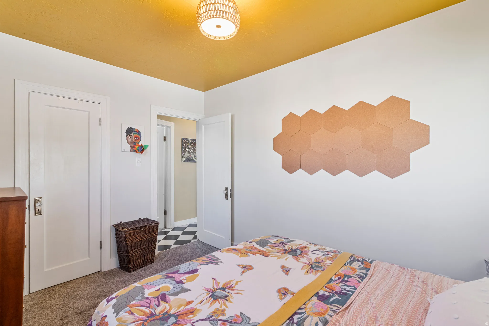Bedroom featuring a textured ceiling fixture, white walls, and a goldenrod-painted ceiling