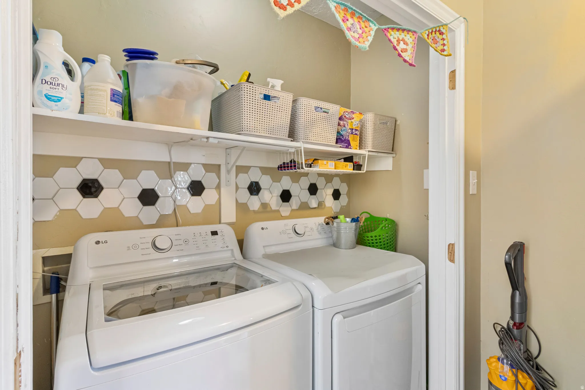 Dedicated laundry area featuring a white top-load washing machine and front-load dryer