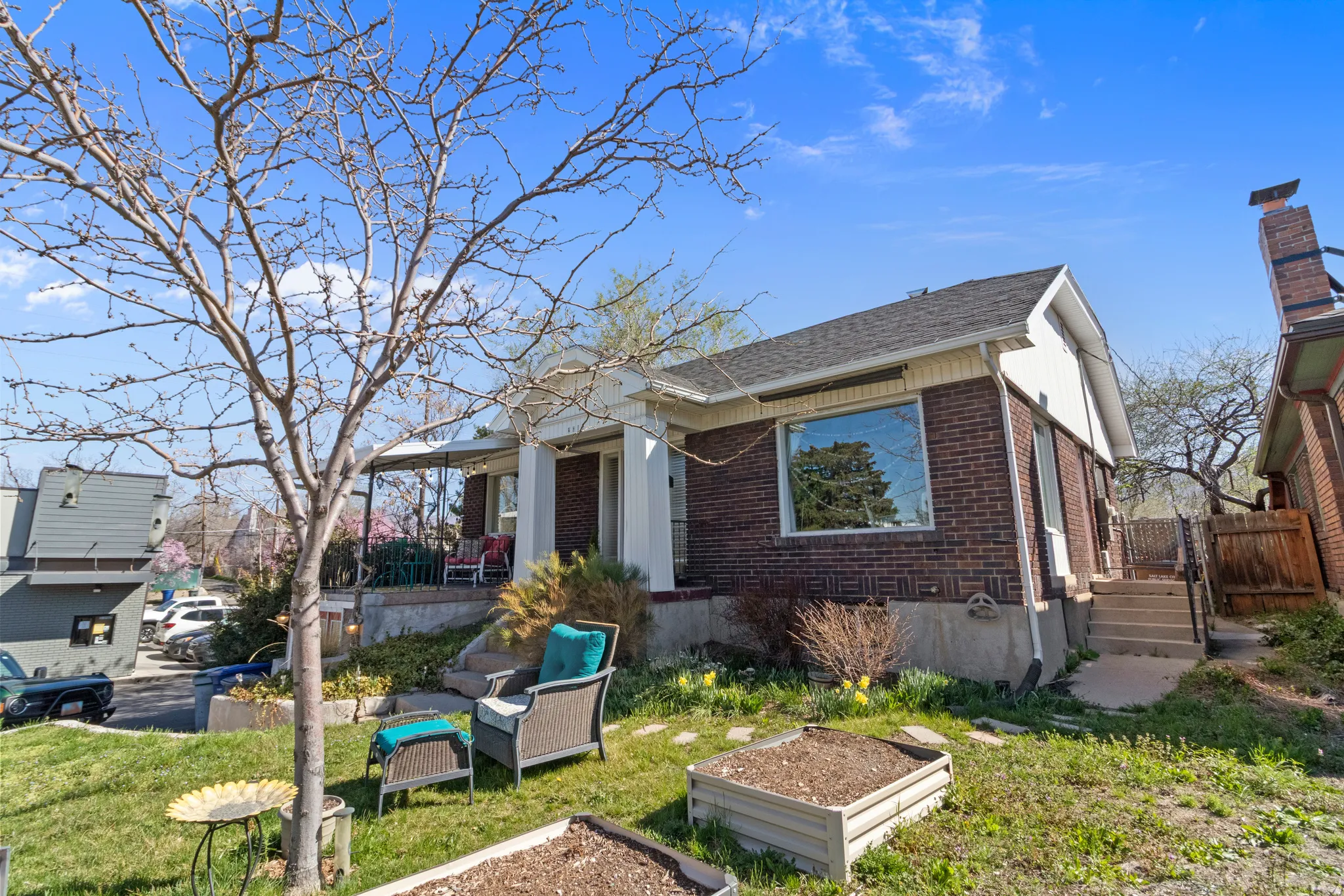 Brick exterior home with white trim and a covered front porch featuring white columns