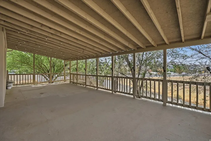 Expansive covered deck providing sheltered outdoor entertaining space