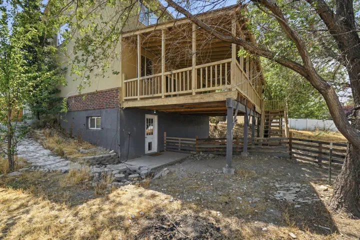 View of covered deck and basement separate entrance