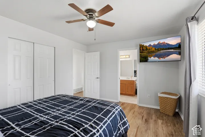 Light-filled room featuring wood-finish flooring, a ceiling fan, and a window with blinds
