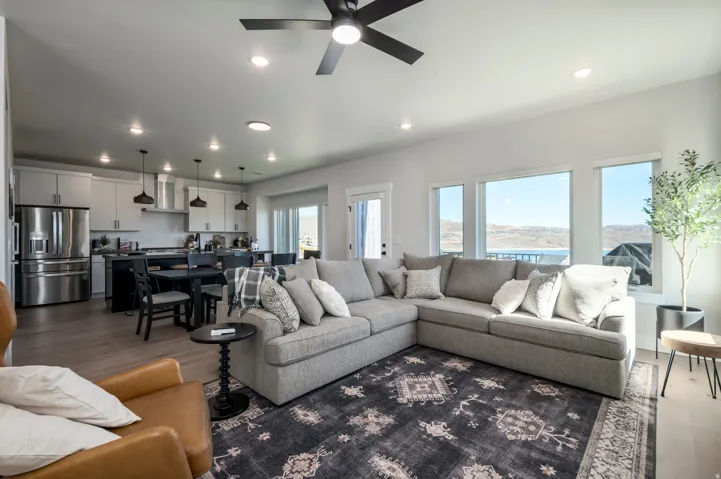Open-concept living area featuring wood-finish flooring, recessed lighting, and multiple windows