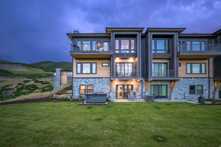 Multi-level exterior with stone and wood siding