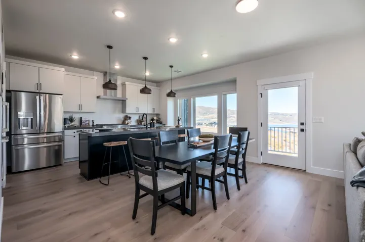 Open concept kitchen and dining area with wood-finish flooring