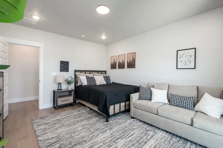 Recessed lighting illuminates neutral walls and wood-finish flooring