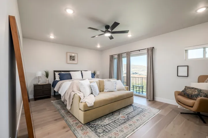 Light wood-finish flooring with a ceiling fan