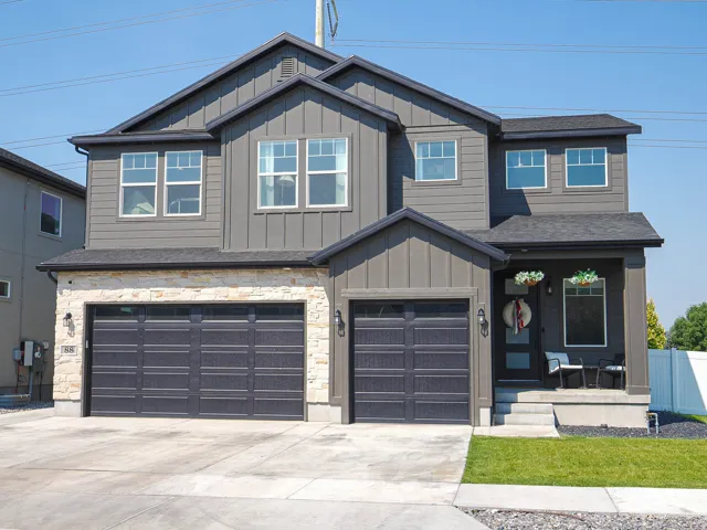 Two-story exterior with board and batten siding and stone accents