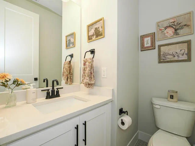 Vanity with a single basin, integrated countertop, and matte black faucet