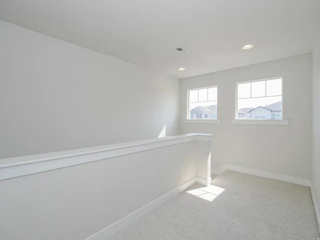 Carpeted flooring, recessed lighting, white trim, and two pane windows