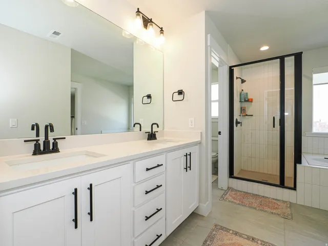 Dual vanity with white cabinetry and matte black hardware