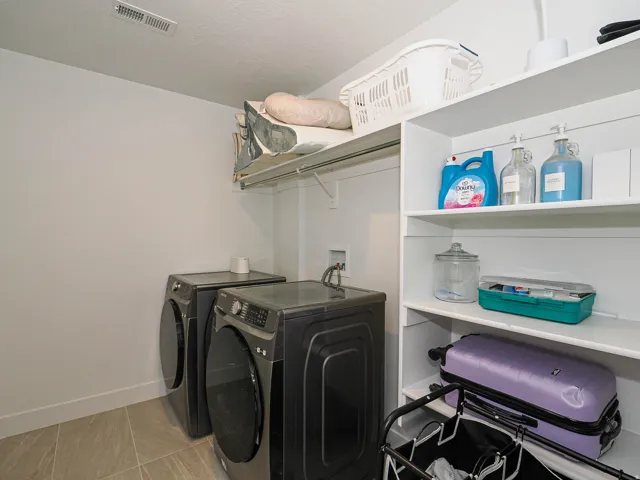 Built-in shelving, laundry hookups, and tiled flooring
