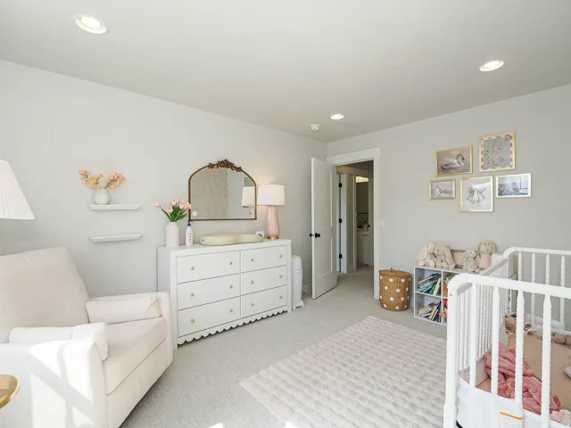Recessed lighting, wall-mounted shelving, neutral wall paint, and white trim