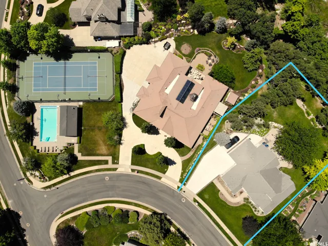 Expansive property featuring a tennis court, swimming pool, and mature trees