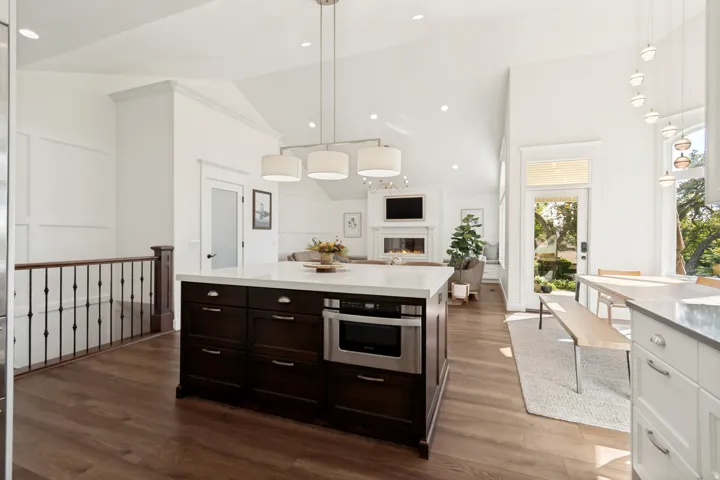 Spacious kitchen island with dark wood cabinetry and integrated microwave