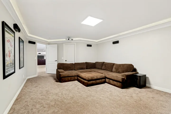 Recessed ceiling lighting, crown molding, and carpeted flooring