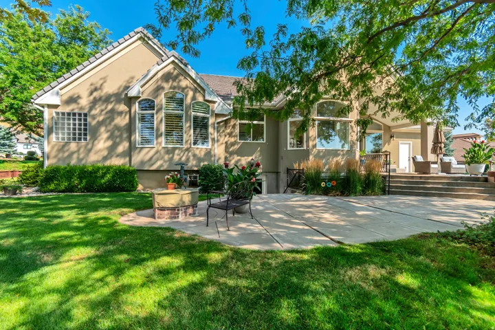Elegant stone exterior with arched architectural detailing and multi-pane windows showcasing abundant natural light