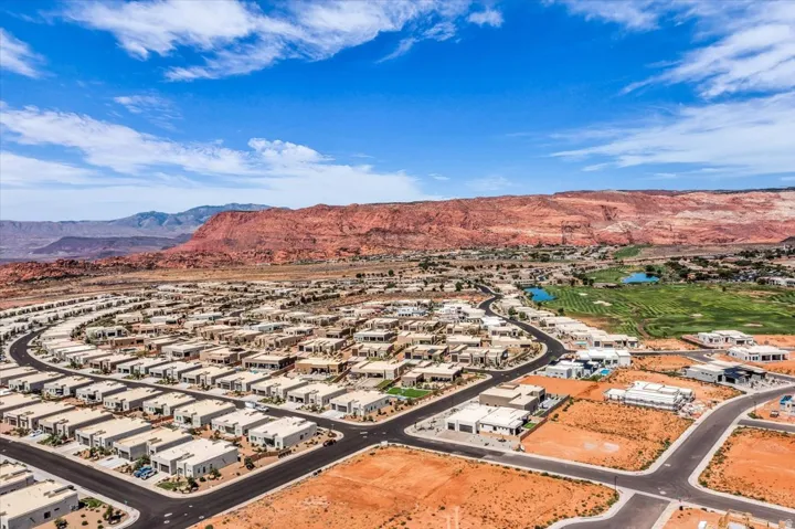 Residential community with diverse architectural styles, featuring golf course access, and surrounded by red rock formations