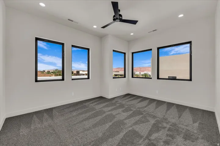 Recessed lighting illuminates the space, complemented by a ceiling fan