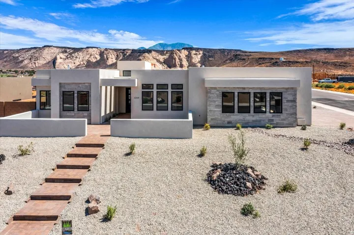 Modern architectural residence featuring clean geometric lines and a minimalist facade with stucco exterior walls