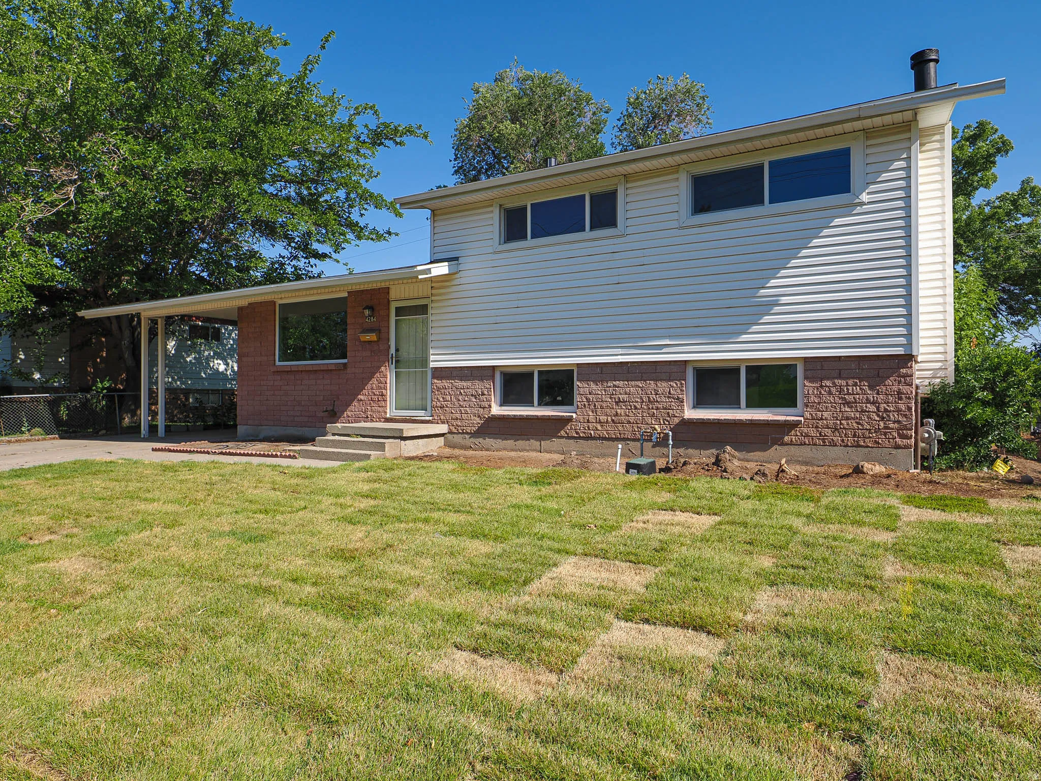Two-story exterior with horizontal siding and brick accents