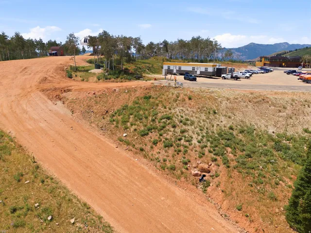 Expansive undeveloped land featuring a dirt road and natural hillside terrain