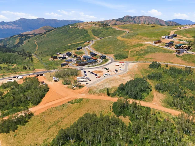 Expansive mountain terrain featuring several developed properties and infrastructure