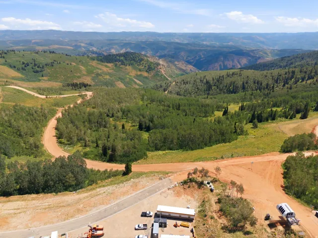 Expansive mountain landscape featuring varied terrain and abundant tree cover