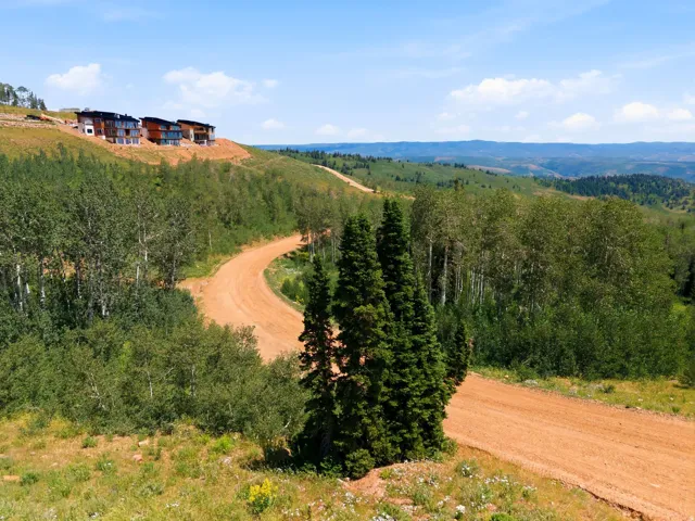 Mountainous terrain featuring modern residences with multiple balconies and large windows