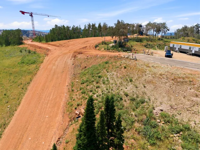 Expansive land parcel featuring graded dirt roads and surrounding natural vegetation