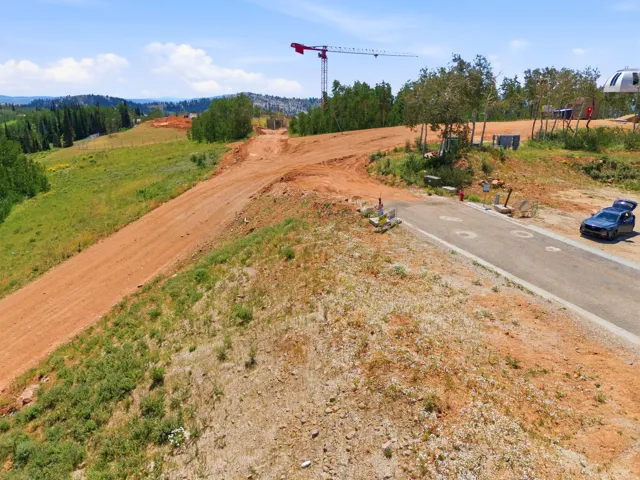Graded terrain featuring a paved roadway and a dirt path