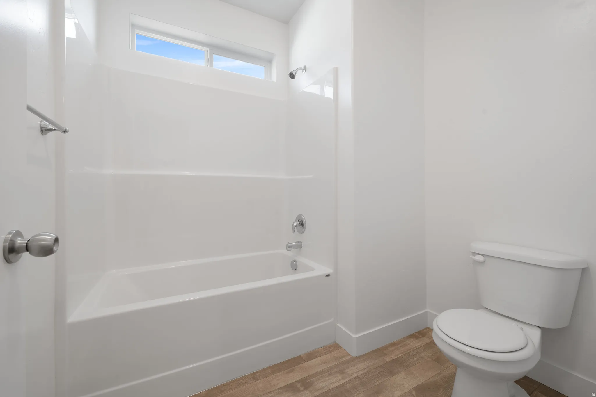 Primary bathroom - Contemporary bathroom, alcove bathtub with chrome fixtures, dual-handle faucet, porcelain toilet with tank, and LVP flooring