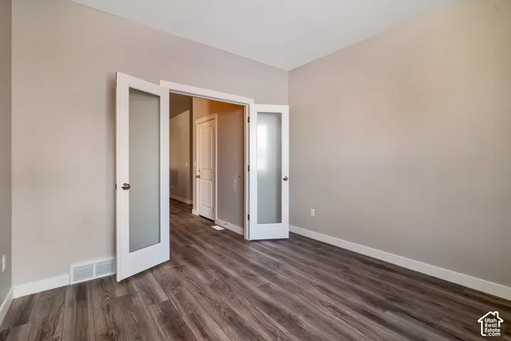 Wood-finish flooring with white baseboards and light-toned walls