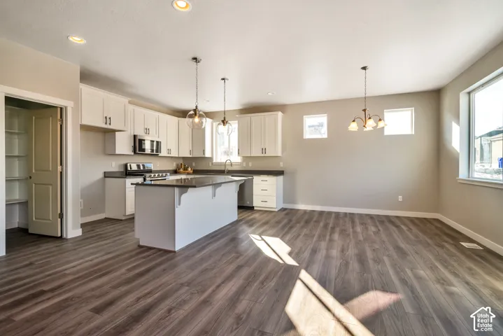 Open-concept living area featuring wood-finish flooring and recessed lighting