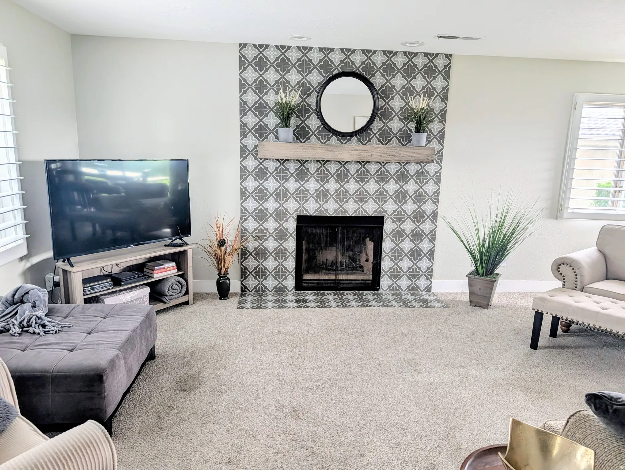 Decorative tiled fireplace with wood mantel