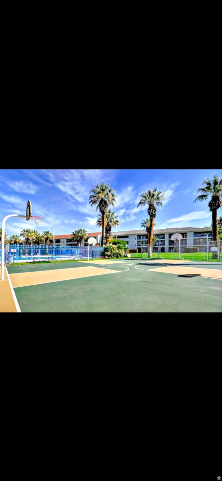 Outdoor basketball court with a green and tan surface