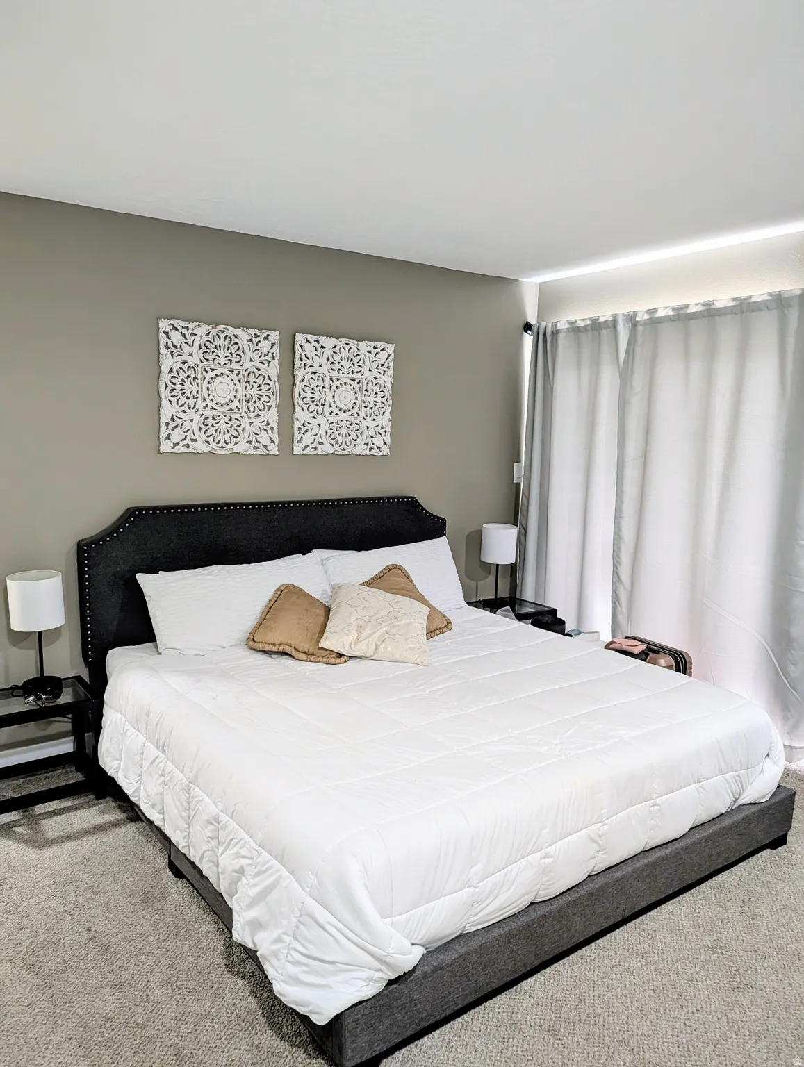 Neutral-toned walls, recessed lighting, and soft gray carpeting